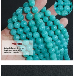 Macro detail of round natural amazonite beads showing smooth texture and teal color