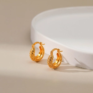 Detail of 18K gold plated hoop earrings showing high-end heavy metal woven texture design