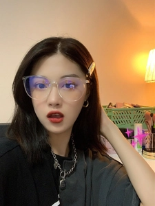 Close-up of clear oversized anti-blue light glasses showing lens coating and resin frame