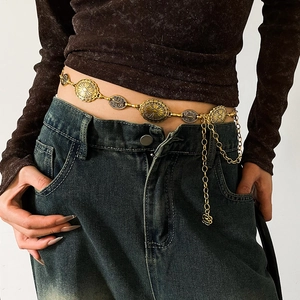 Close-up of gold bohemian waist chain with textured oval plates and rose pendant