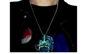 Close-up of a men's luminous scorpion pendant necklace worn by a model in silver finish