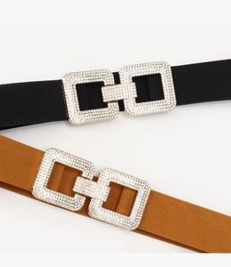 Detail of black and brown elastic wide belts with sparkling square rhinestone buckles