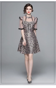 Detail of beaded bodice with pearls and lace trim on a floral waist-slimming dress