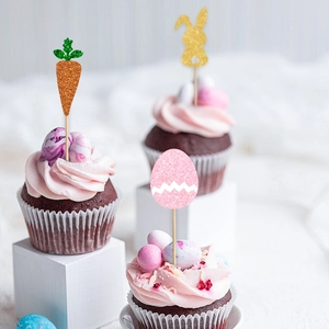 Glittery Easter cupcake toppers featuring a carrot, bunny silhouette, and decorated egg