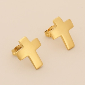 Detailed view of 18K gold plated stainless steel cross stud earrings on a beige surface