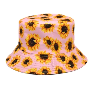 Detailed view of pink bucket hat with sunflower print and durable stitched cotton fabric