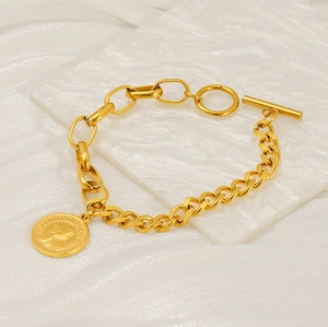 Close-up of gold chain bracelet with Queen head coin pendant and toggle OT clasp detail