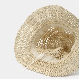 Detail view showing breathable hollow weave pattern and adjustable strap of the sun hat