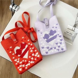 Cute knitted mini phone crossbody bag with contrast heart patterns and snap closure