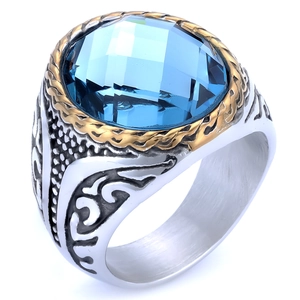 Detail showing vintage ring with large blue gemstone and ornate engraved silver band