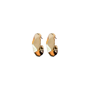 Irregular geometric C-shaped gold plated stud earrings with a polished metallic finish