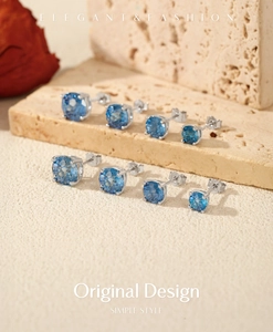 Detailed macro view of four pairs of sapphire blue round cut 925 silver stud earrings