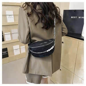 Detail of black marble textured crescent bag with pearl chain and zigzag strap