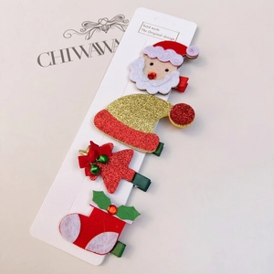 Détail du lot de 4 barrettes de Noël avec Père Noël et sapin sur carte de présentation