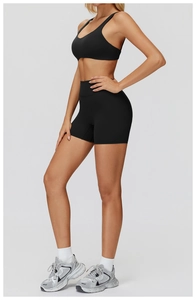 Side view of black athletic set featuring U-neck tank top and high-waisted yoga shorts