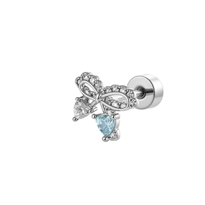 Silver bow stud earrings with light blue and clear heart stones on a white background