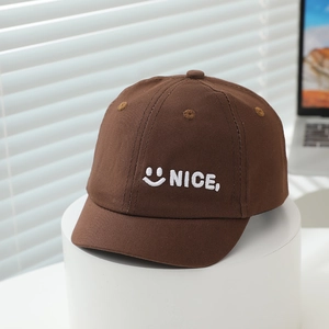 Detail of dark brown baby baseball cap with white embroidered smile and NICE text
