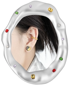 Close-up of golden lava texture earrings with multi-color gemstone wavy silver border