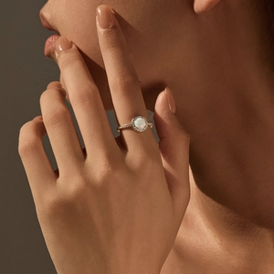 Elegant gold S925 silver ring featuring a round white opal stone and diamond accents