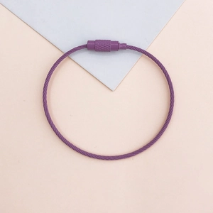 Detail of purple coated wire keychain with screw lock on geometric background