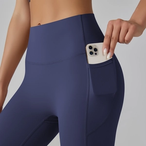 Detail of high-waisted yoga leggings showing functional side pocket for a smartphone
