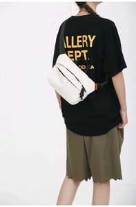 Close-up of minimalist white waterproof crossbody bag with orange label on back