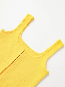 Detail view of yellow knit top featuring square neckline and metallic hook-and-eye closures