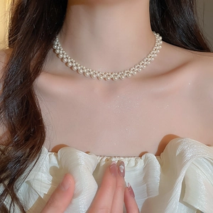 Detailed view of double-layered pearl choker necklace on neck with elegant luster