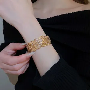 Elegant hollow butterfly gold cuff bracelet for women shown on model wrist