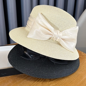 Elegant French style straw sun hat with large satin bow for beach and summer travel