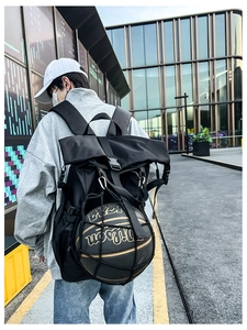 Outdoor shot of the black athletic backpack featuring an external mesh net for carrying a basketball