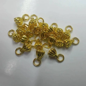 Golden lotus seed pod jewelry pendants made of gold-plated metal on white background
