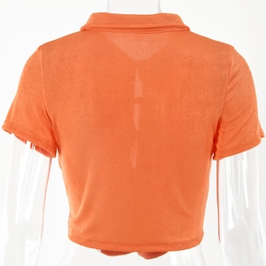 Rear view of orange short sleeve crop top with collared neck and knit texture