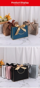 Detail of luxury cardboard gift bags with silk bow decorations and rope handles