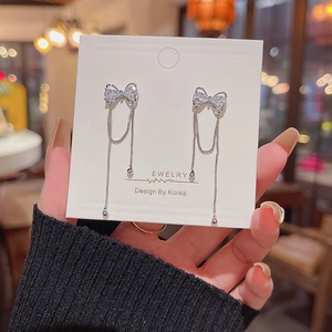 Detailed view of silver butterfly tassel earrings with sparkling clear cubic zirconia