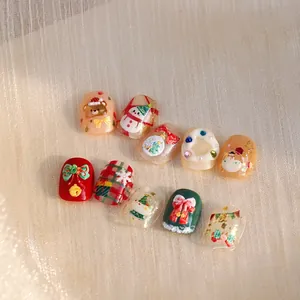Detailed close-up of 3D Christmas nail stickers featuring festive bears and bow designs