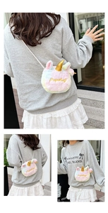 Detail showing plush rainbow unicorn crossbody bag with golden horn and woven strap