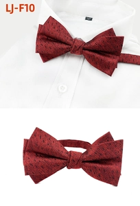 Close-up of wine red men's bowtie with black dots on white shirt for formal events