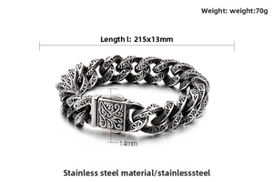 Macro view of vintage stainless steel link bracelet with floral skull carvings and dimensions