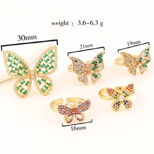 Macro view of five butterfly rings with colorful cubic zirconia and gold plating