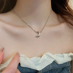 Minimalist silver moon pendant choker necklace on model showing refined metal luster
