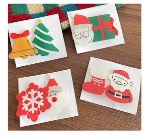 Detail view of 8pcs Christmas hair clips set with Santa and tree motifs on white card