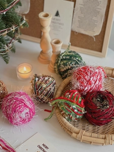 Detail of colorful mixed yarn balls for Christmas DIY crafts on a rustic tray