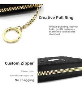 Close-up of premium gold zipper and round ring puller on black woven leather card holder