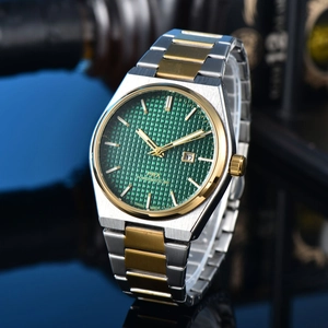 Detailed shot of men's watch with green textured dial and silver gold bicolor strap