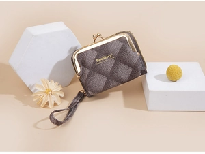 Detailed view of dark grey quilted mini wallet with metallic kiss lock and wrist strap