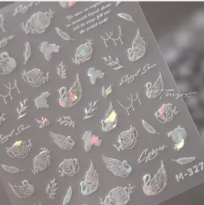 Macro detail of holographic swan and rose nail stickers with iridescent aurora finish