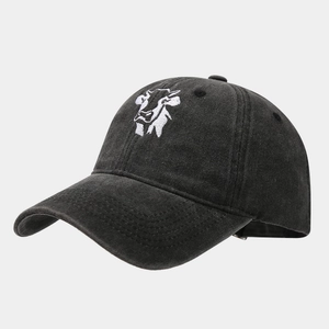 Detail of vintage charcoal black washed cotton baseball cap with cow embroidery on front
