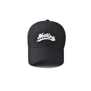 Close-up of premium 3D white Nothing embroidery on a black cotton baseball cap