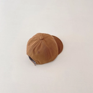 Detail view of cotton baby baseball cap with adjustable strap in caramel brown